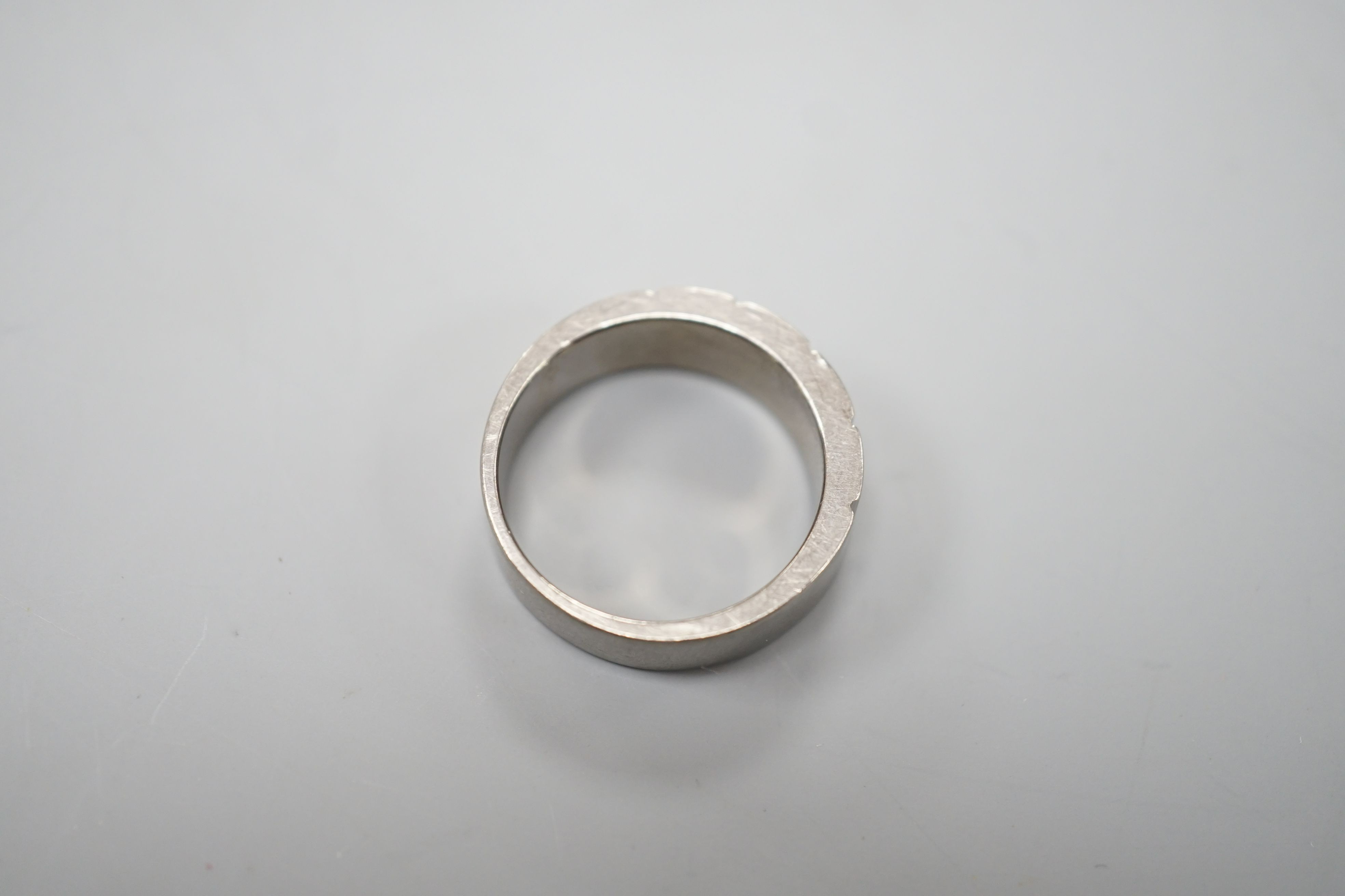 A diamond set titanium dress ring, size P, gross 3.3 grams